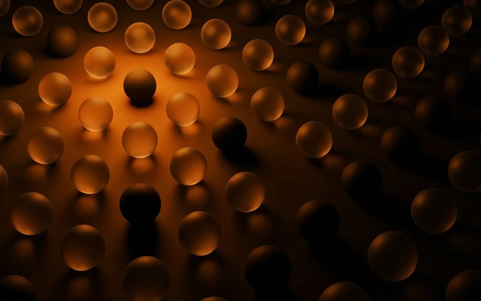 Copertina: sfere di vetro, luce ambra su fondo nero